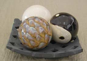 three ceramic balls on pierced plate, grupo de tres bolas ceramicas decoradas sobre plato perforado